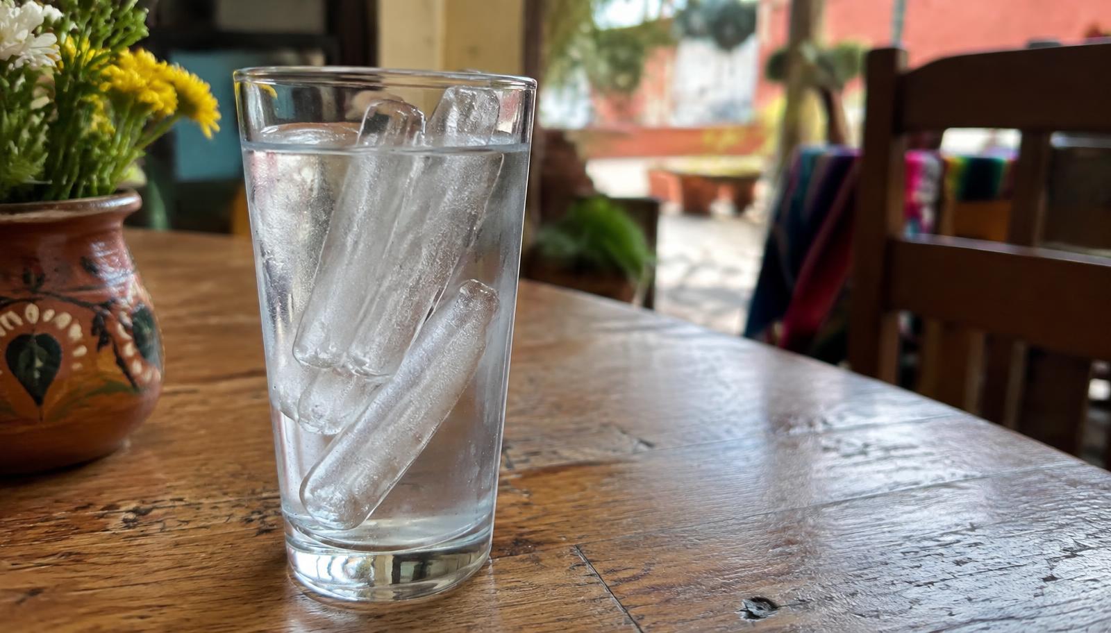 A glass of purified water with ice on a table in Cancun